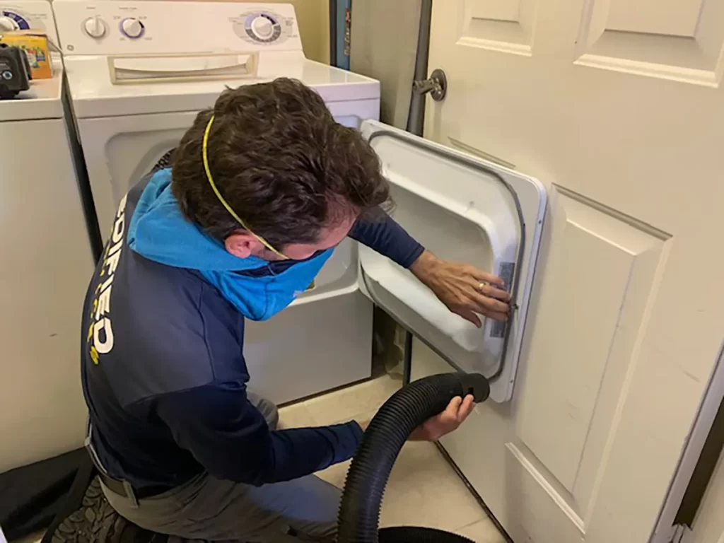 Edified Services rep cleaning dryer